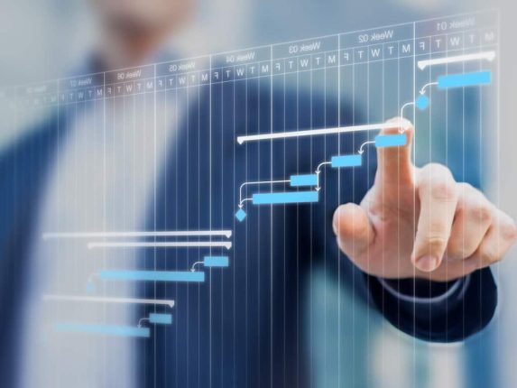 Man uses a touch screen of a digital laboratory planning Gantt chart