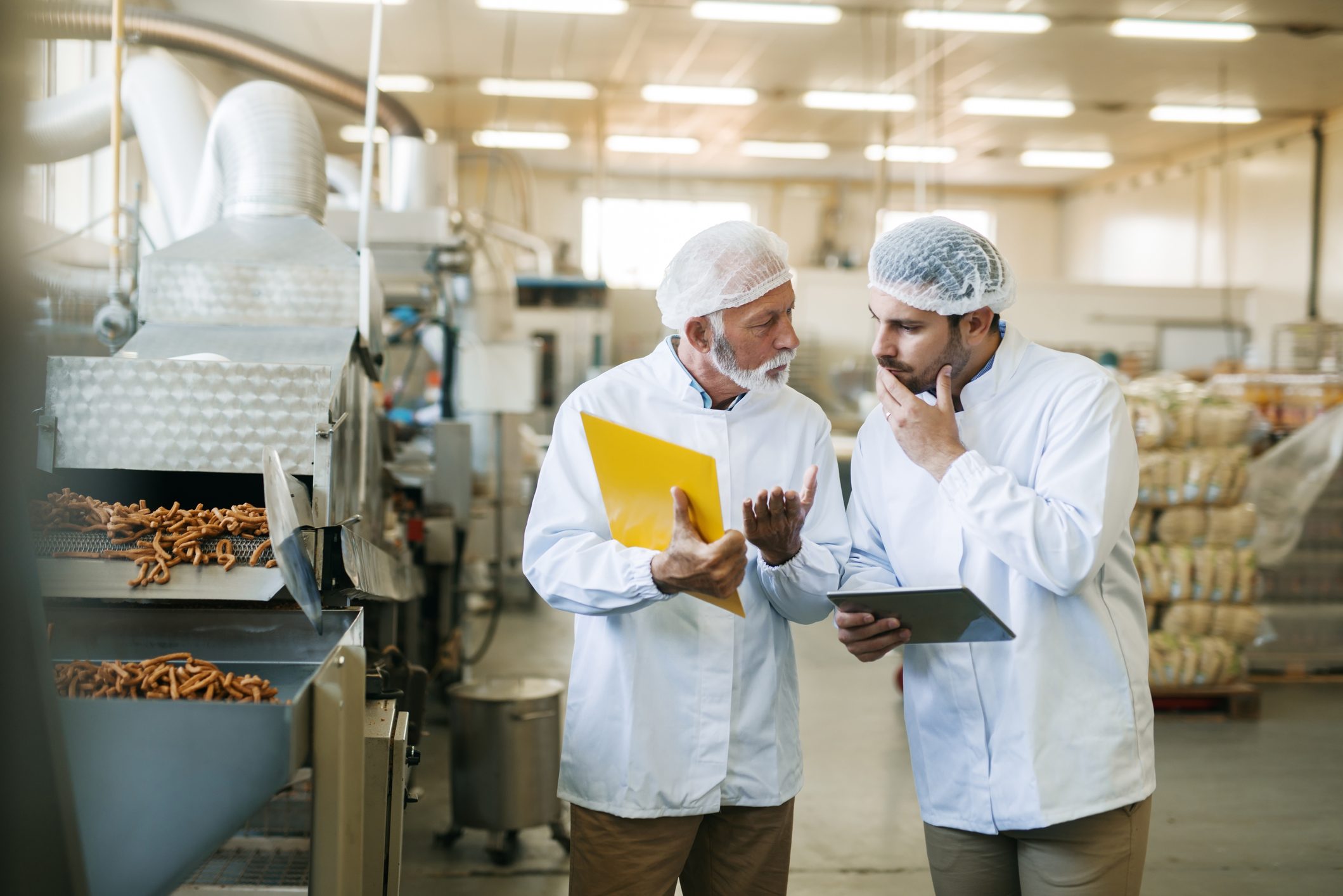 Workers talking about food quality.