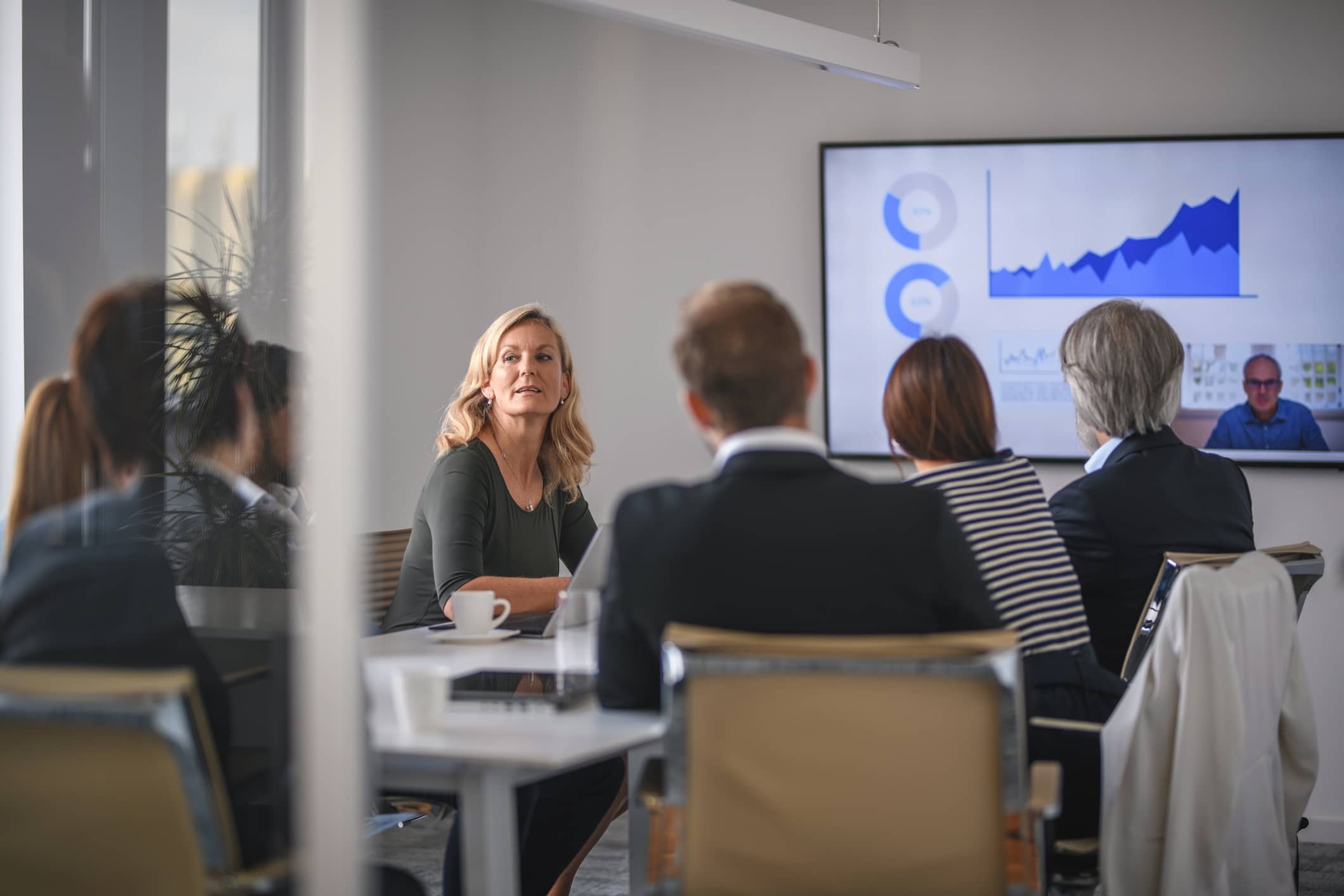 Businesswoman Listening to Associate During Video Conference