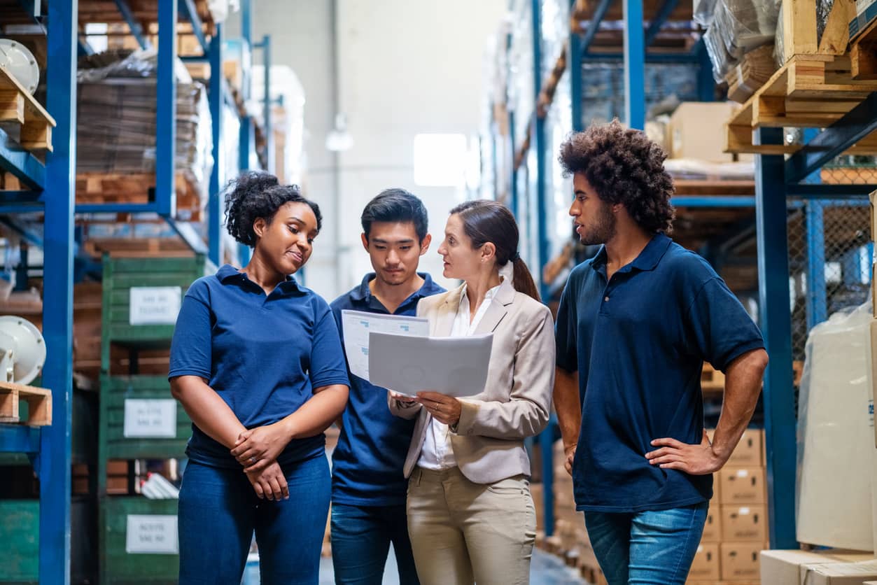 Female manager discussing delivery schedules with staff