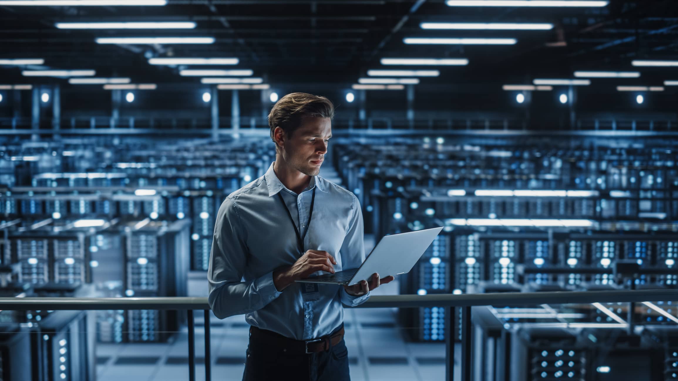 Portrait of IT Specialist Uses Laptop in Data Center.