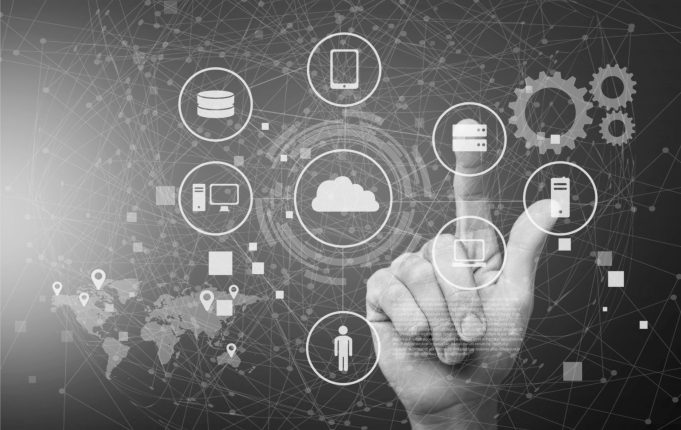 Supply chain graphic with a world map and icons for a computer, man, cell phone, the cloud and more