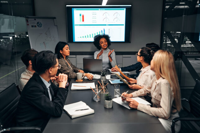 Young professionals discuss statistics in meeting room