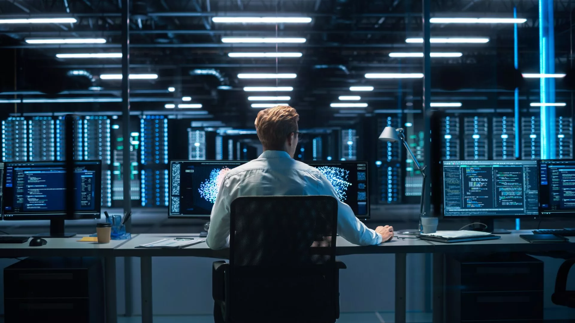 Back View of the Male Computer Engineer and Scientist Create Neural Network. In Office Displays Showing 3D Simulation of Big Data, Machine Learning Processes, Web3 Programming Concepts