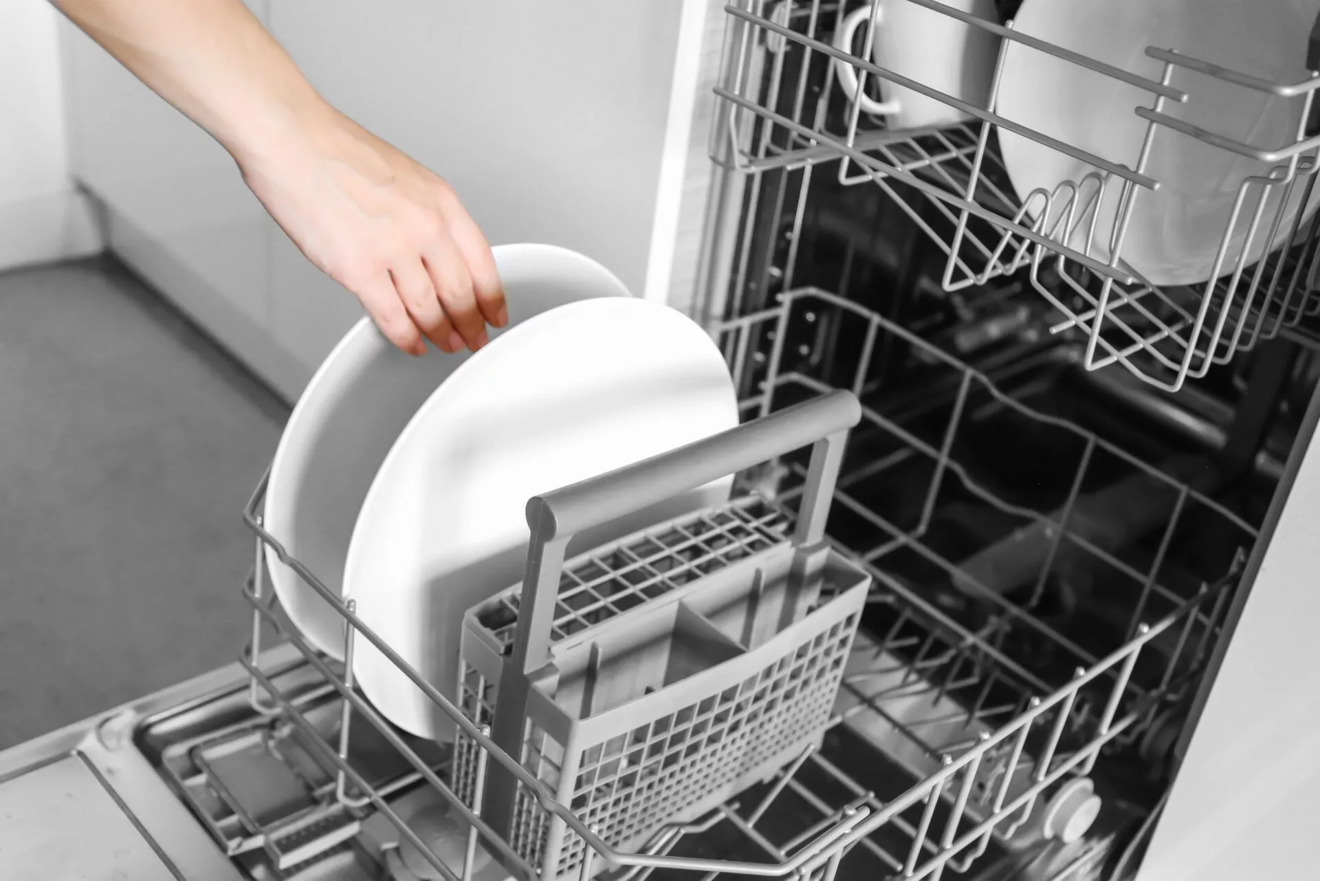 Loading dishes. Dishwashing capsules. Open dishwasher with clean dishes in the white kitchen. Opening and closing the dishwasher.
